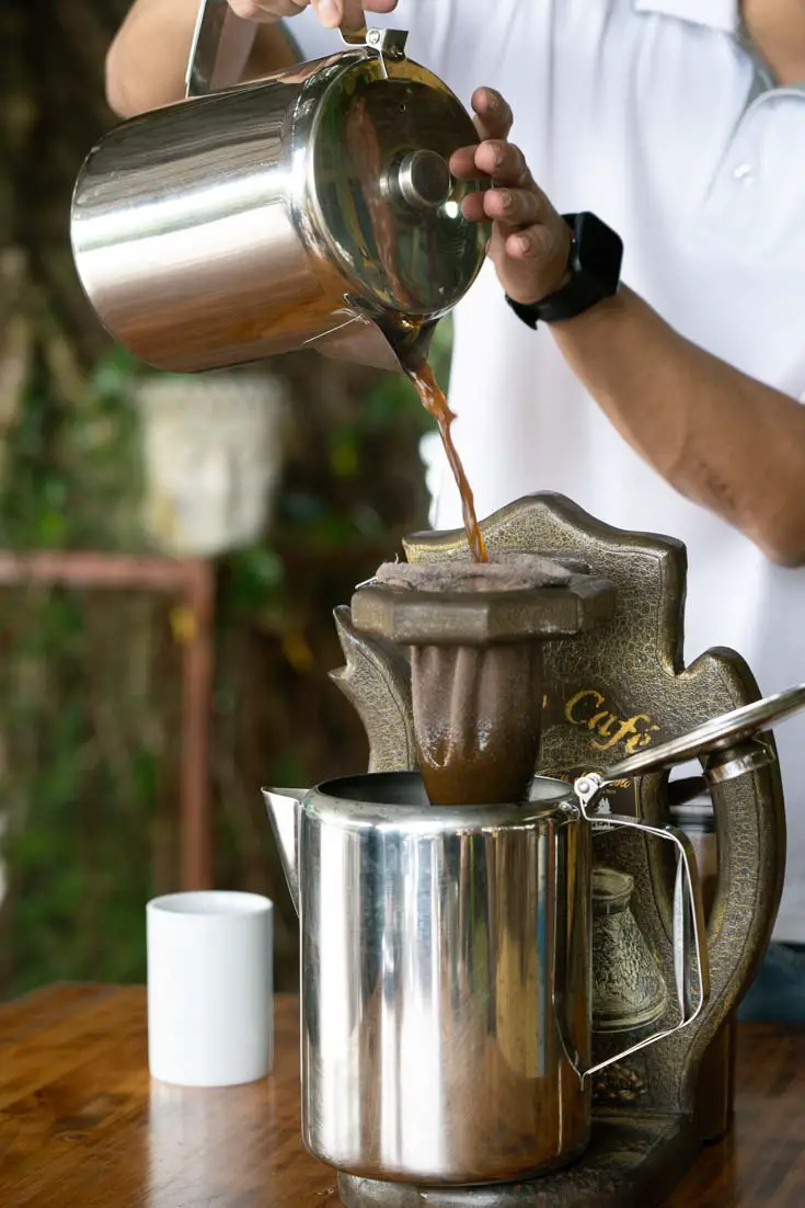 Person pouring coffee through a filter