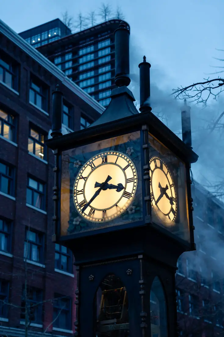 Historic street clock emitting steam