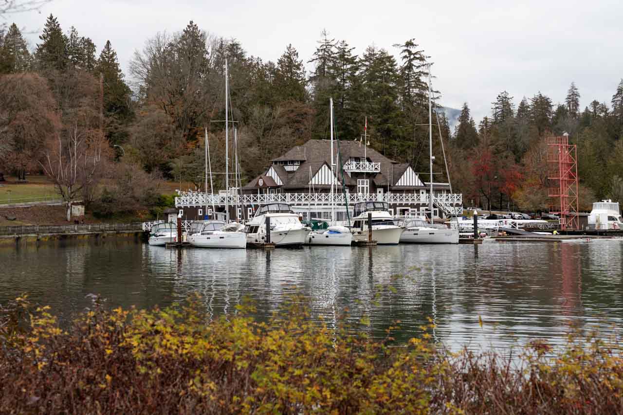 Vancouver Rowing Club building viewed across water framed by autumnal foliage