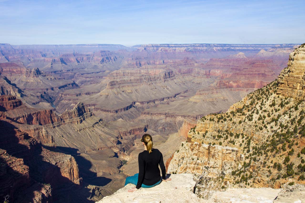 Madam ZoZo sitting on ledge overlooking Grand Canyon