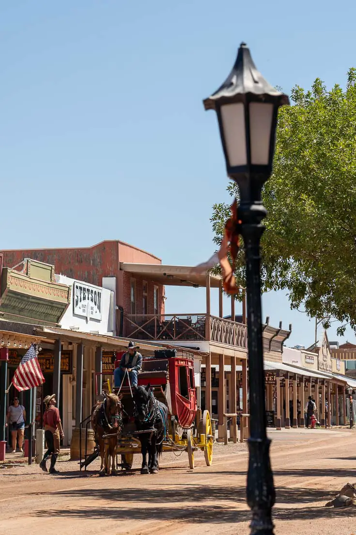 Horse and red carriage in the dusty main street of old pioneer town of Tombstone on a sunny day