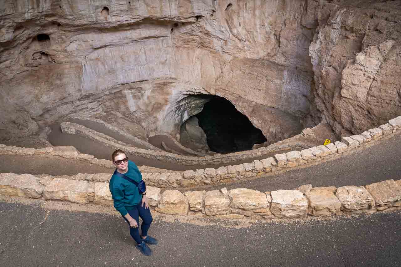 Woman in green on switchbacks leading into Carlsbad Caverns natural entrance