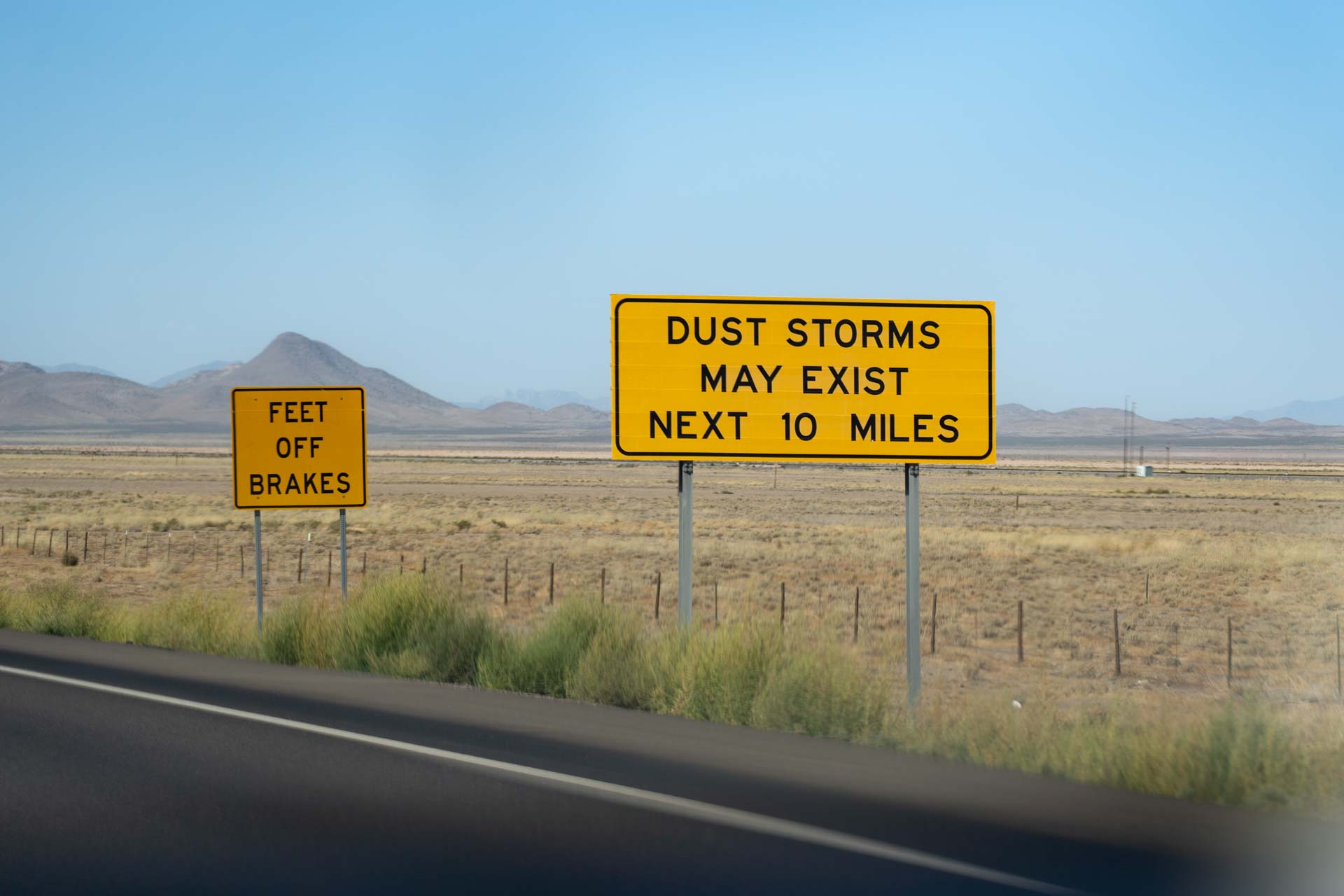 Road sign reading "Dust storms may exist next 10 miles"