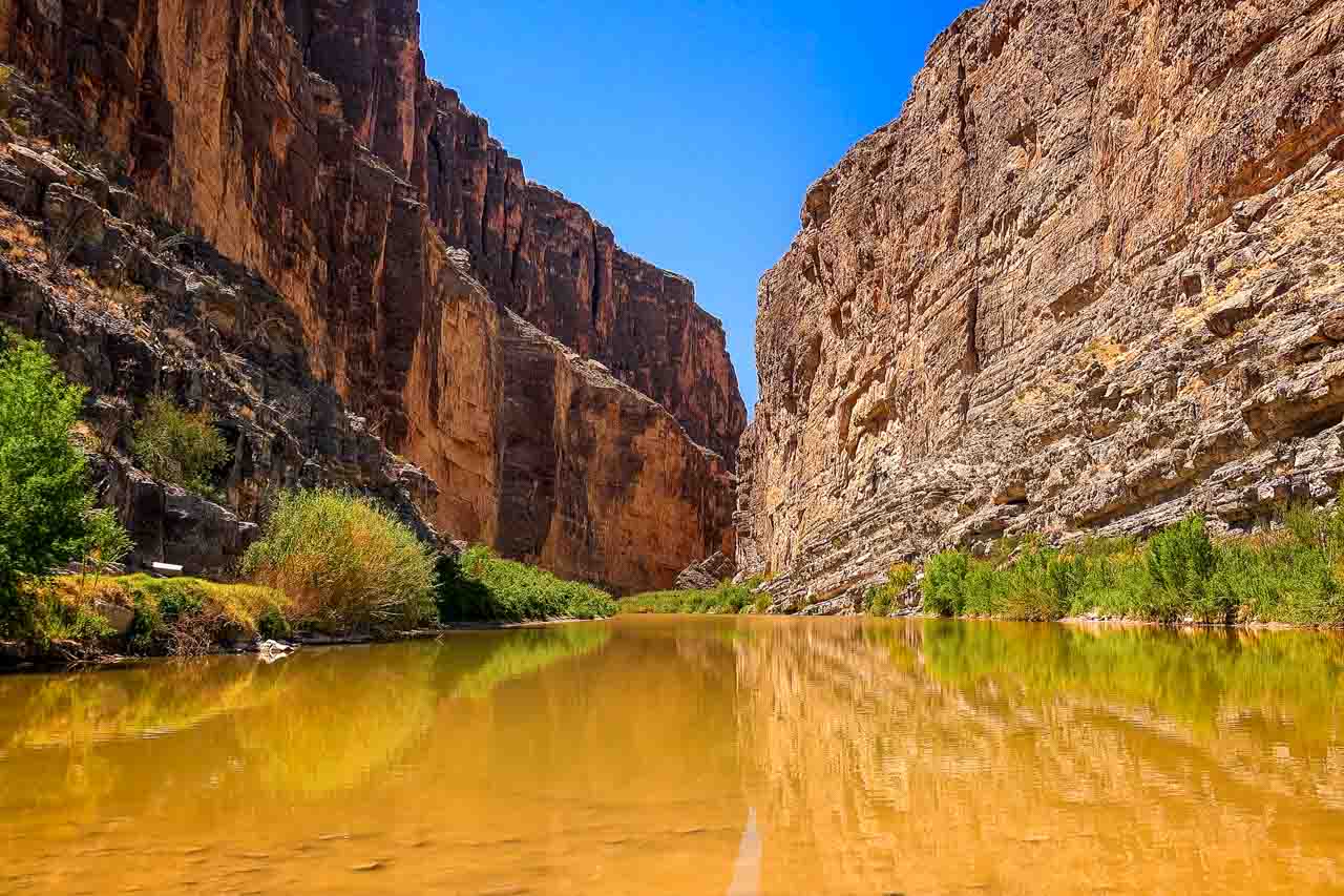 Photo of large rock canyon rising infront Rio Grande River