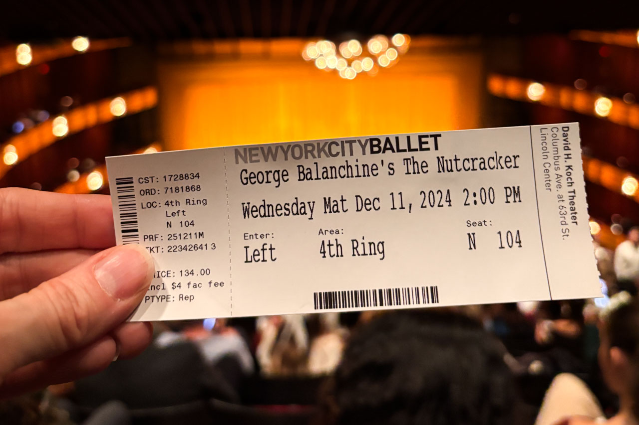 Hand holding ticket to the Nutcracker inside the David H. Koch Theater