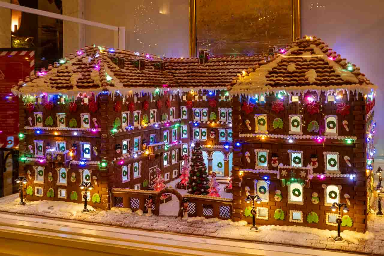 Gingerbread replica of Lotte New York Palace illuminated with coloured lights and festive decorations