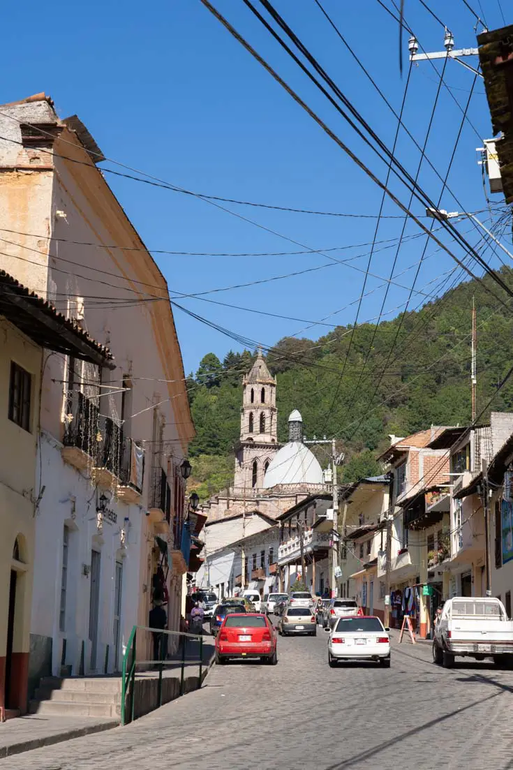 Looking up the main street of a small, rural town towards a church steeple