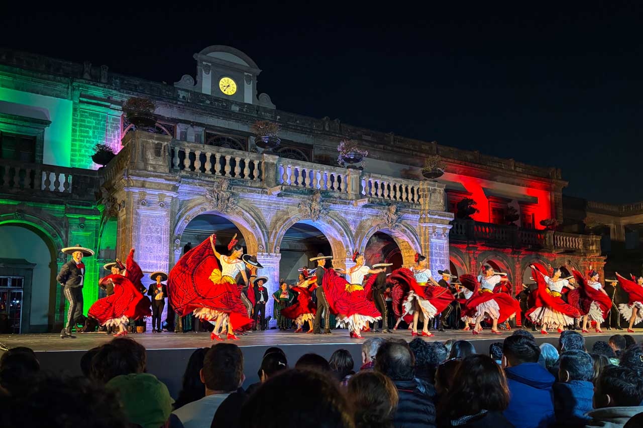 Ballet Folklorico performing infront of Chapultepec Castle lit up in the national colours of Mexico