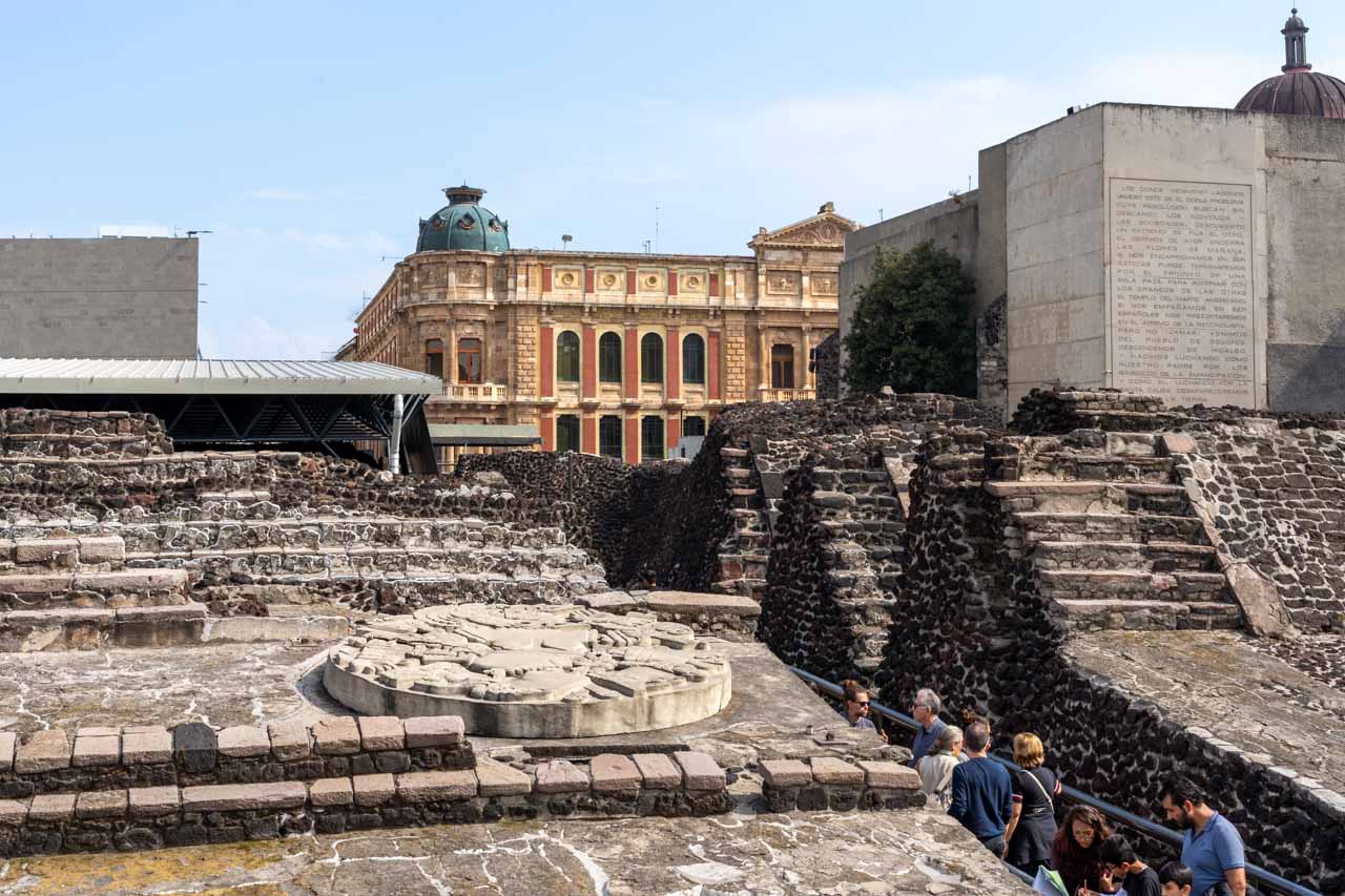 Aztec archaelogical site in central historic district of Mexico City with colonial buildings in the background 