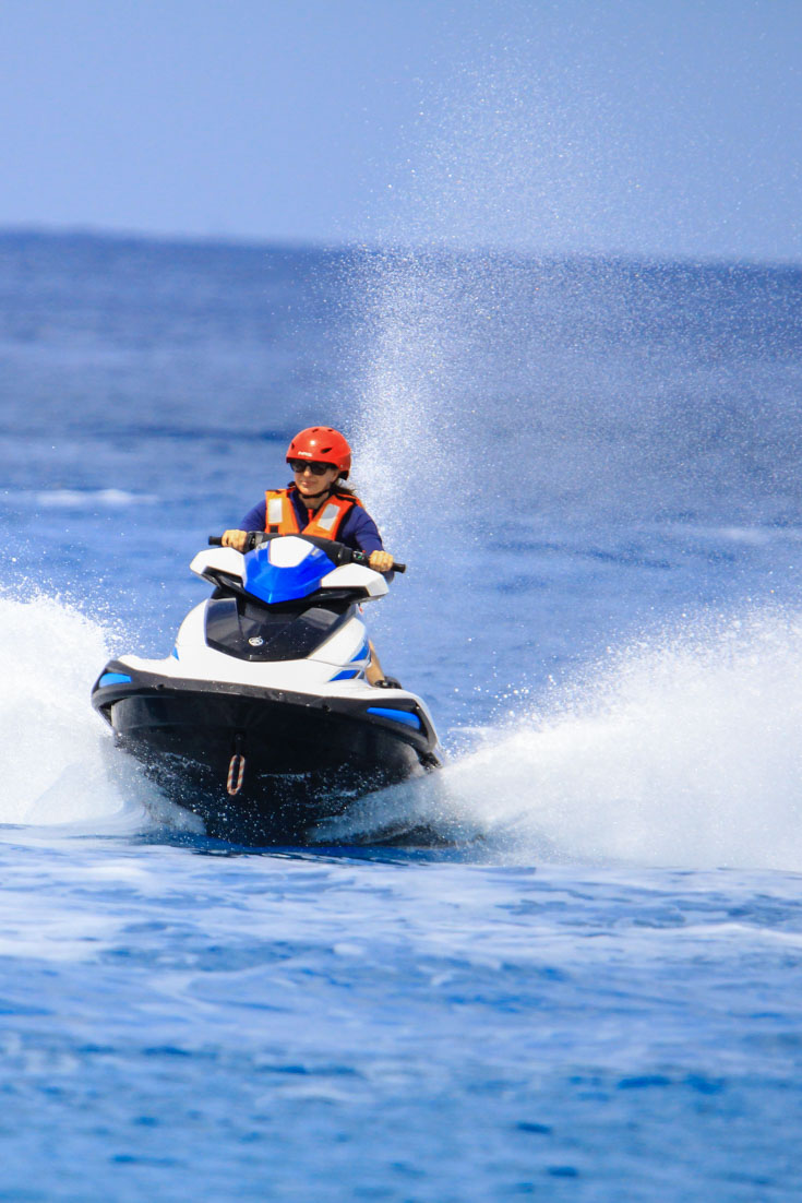 Woman in orange lifevest on a jetski