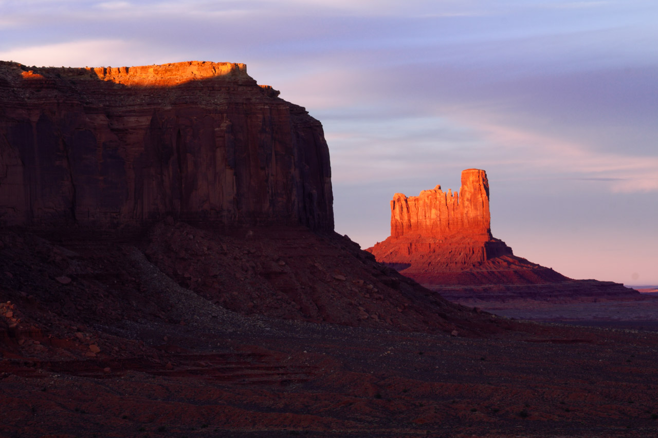 Sunset glow and shadows on the mesas and buttes of Monument Valley