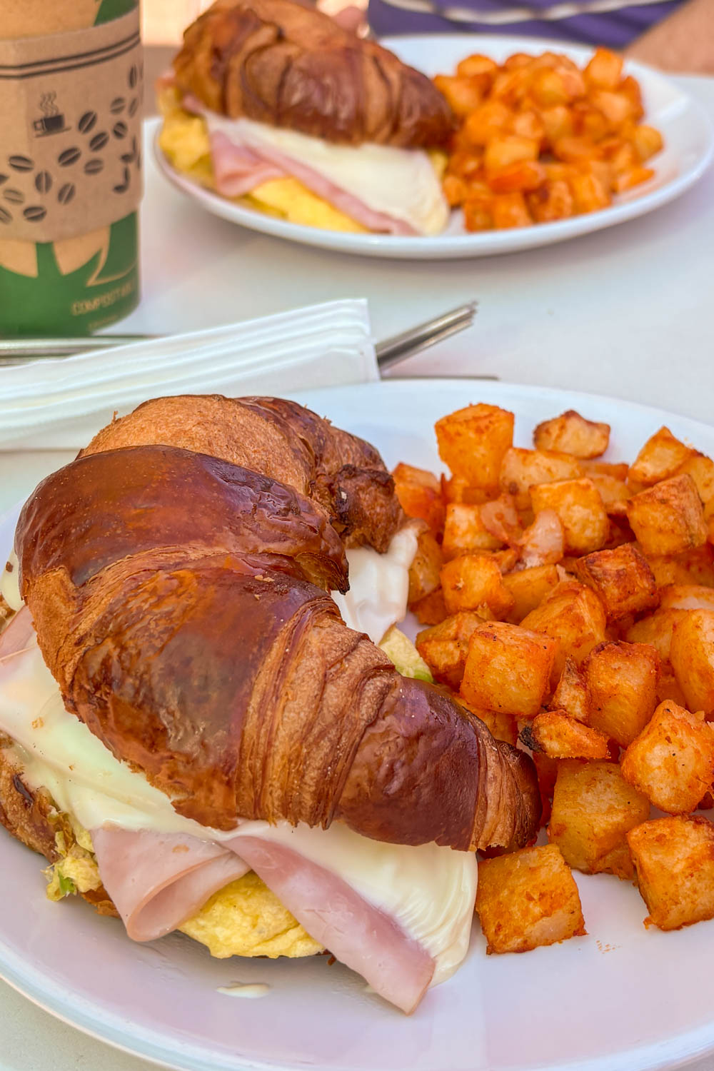 Ham, cheese and egg crossiant with breakfast potatoes 