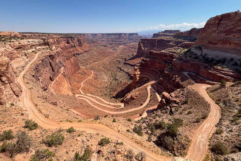 Image of dirt road winding down steep mesa wall into canyon