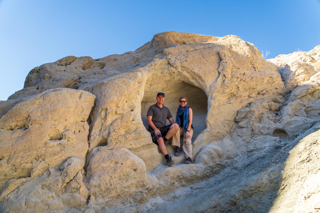 Couple sitting inside rock formation in the Coachella Valley
