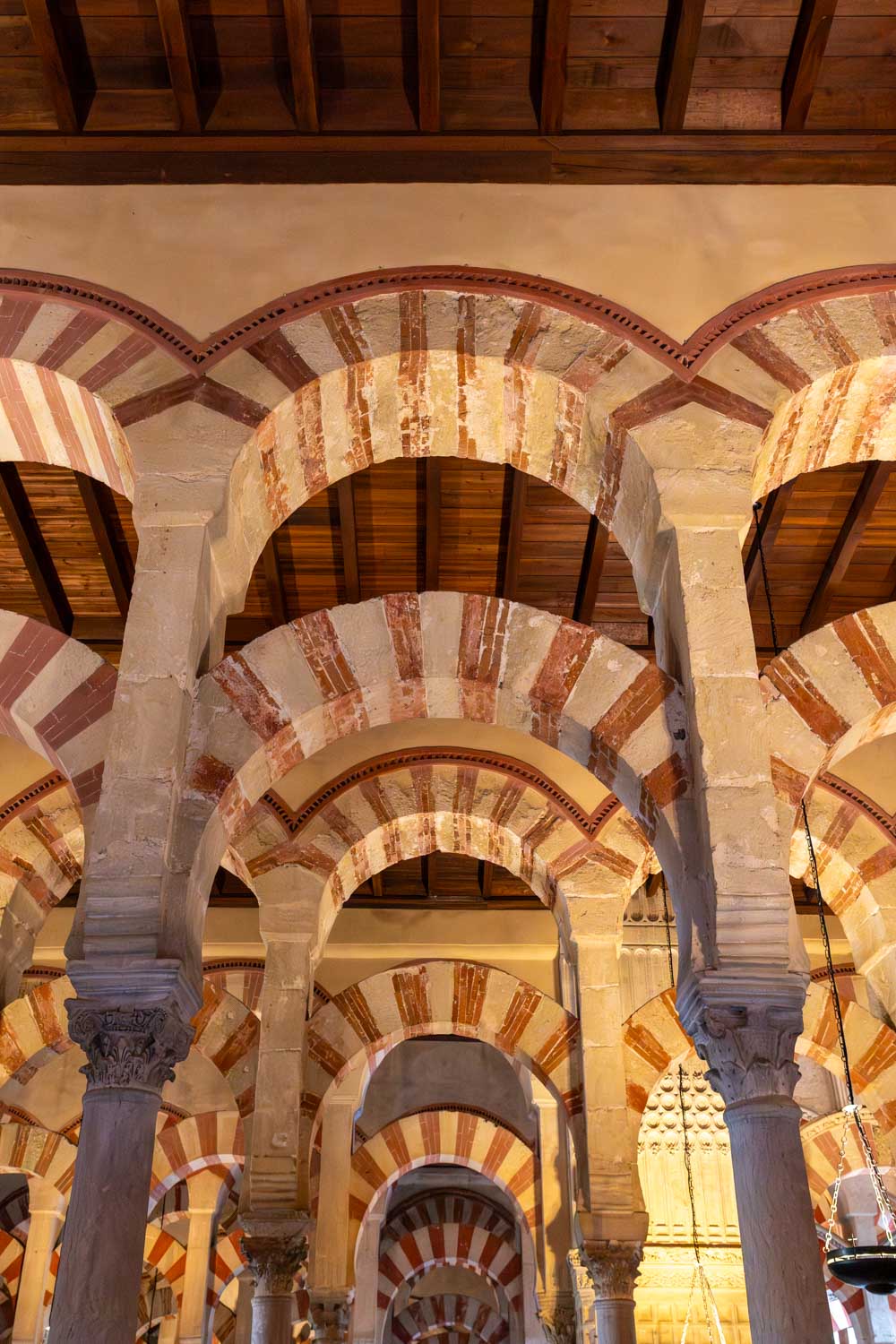 Rows of double arches and columns, with red and white striped paint