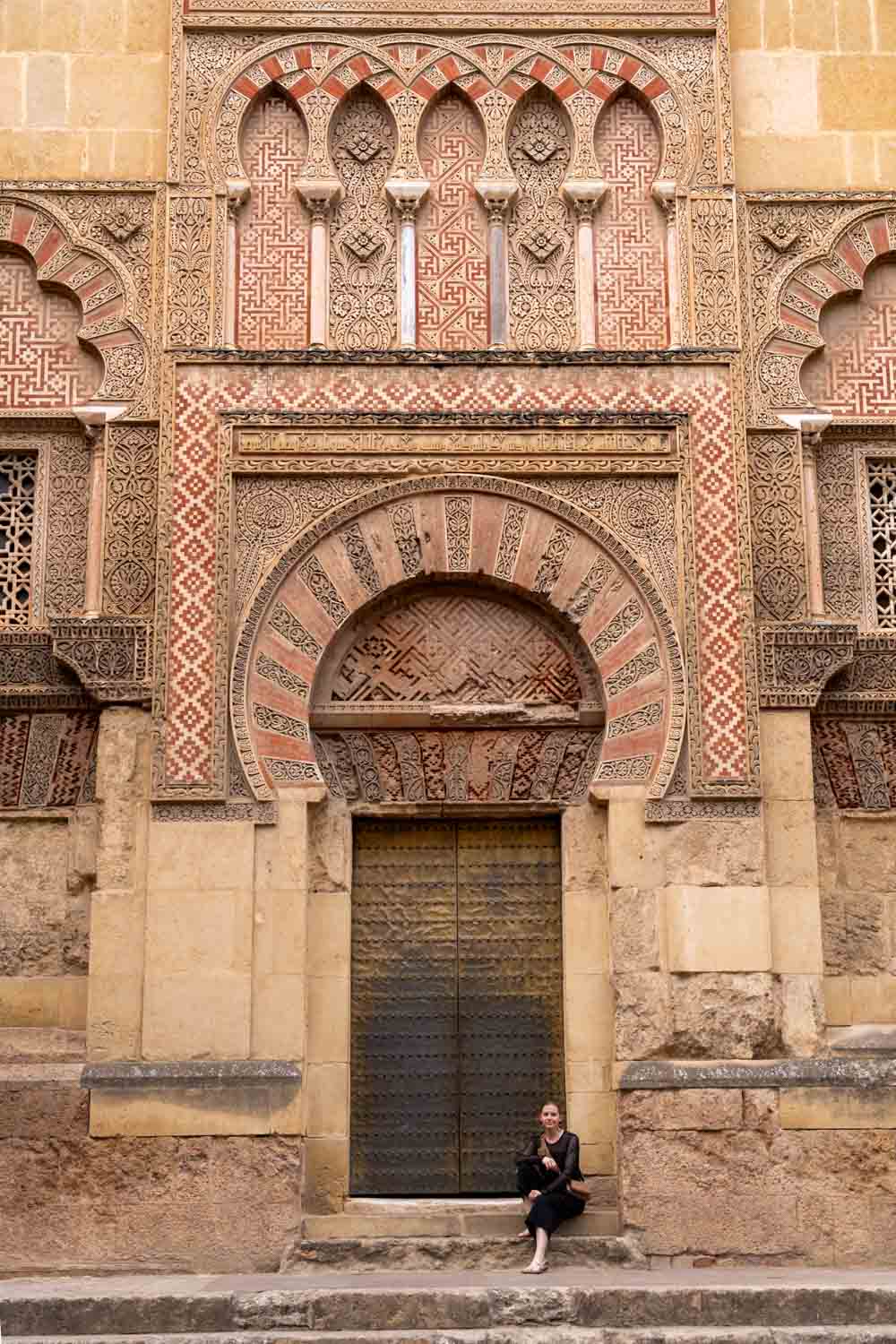 Madam ZoZo sitting by external door of Cordoba's Mosque-Cathedral