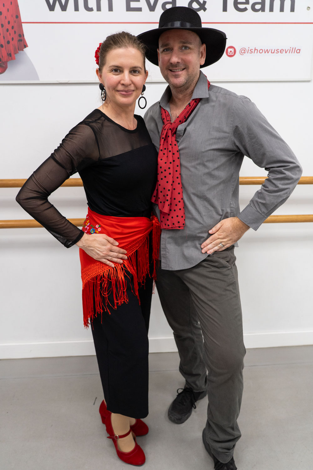 Madam ZoZo and husband posing for photo, dressed for a flamenco dance lesson