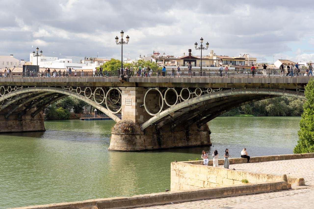 Historic bridge over the Guadalquivir River, with ornate ironwork