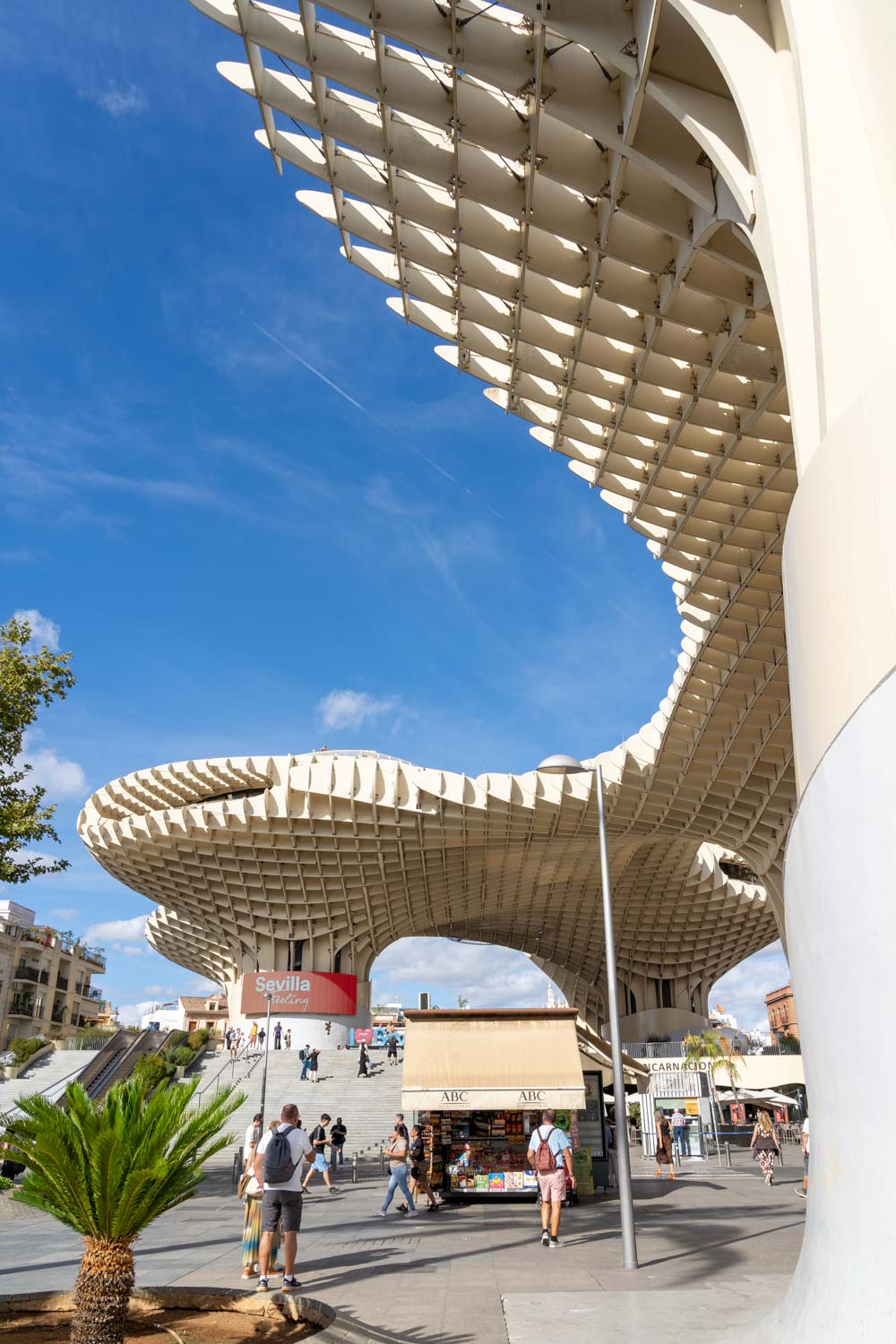 Large, sculptural, wood structure located over street and square
