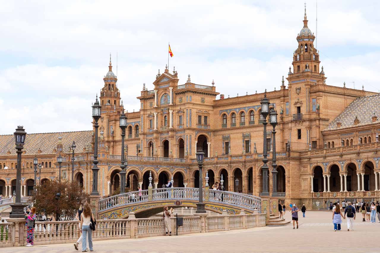 Plaza de España architecture with tiled bridge over canal in foreground
