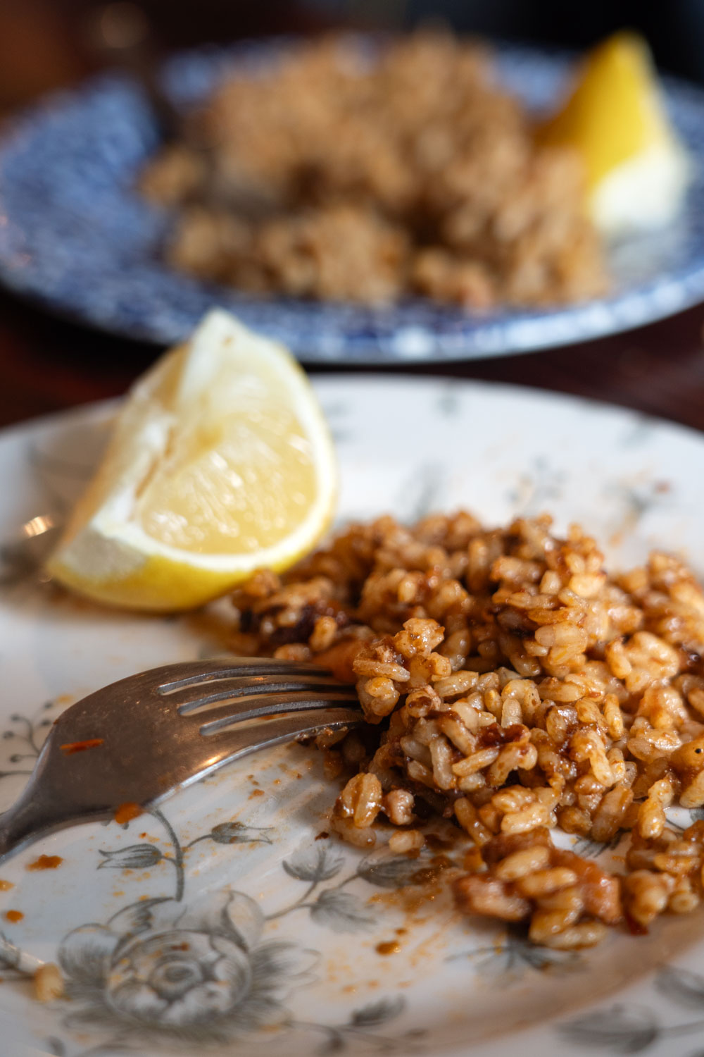 Decorative plates of paella with lemon quarters