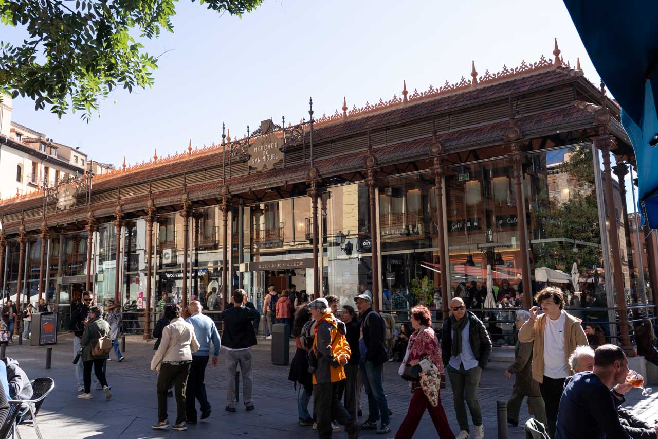 Exterior of busy market with glass walls on a sunny afternoon