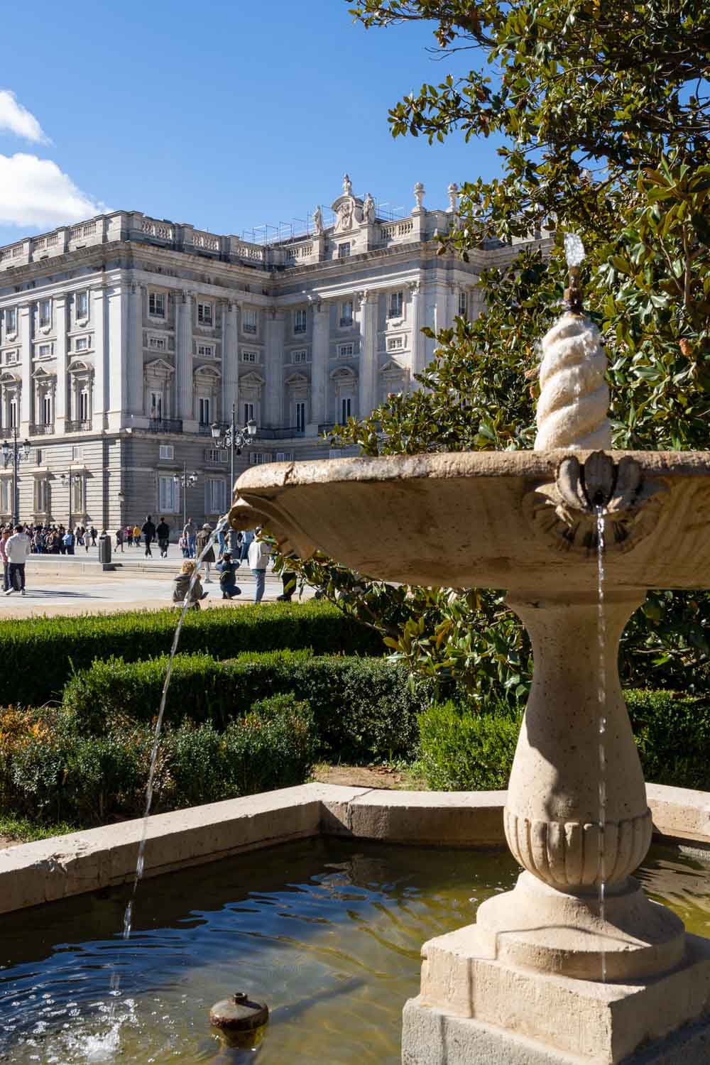 Royal Palace of Madrid with fountain and formal garden in the foreground