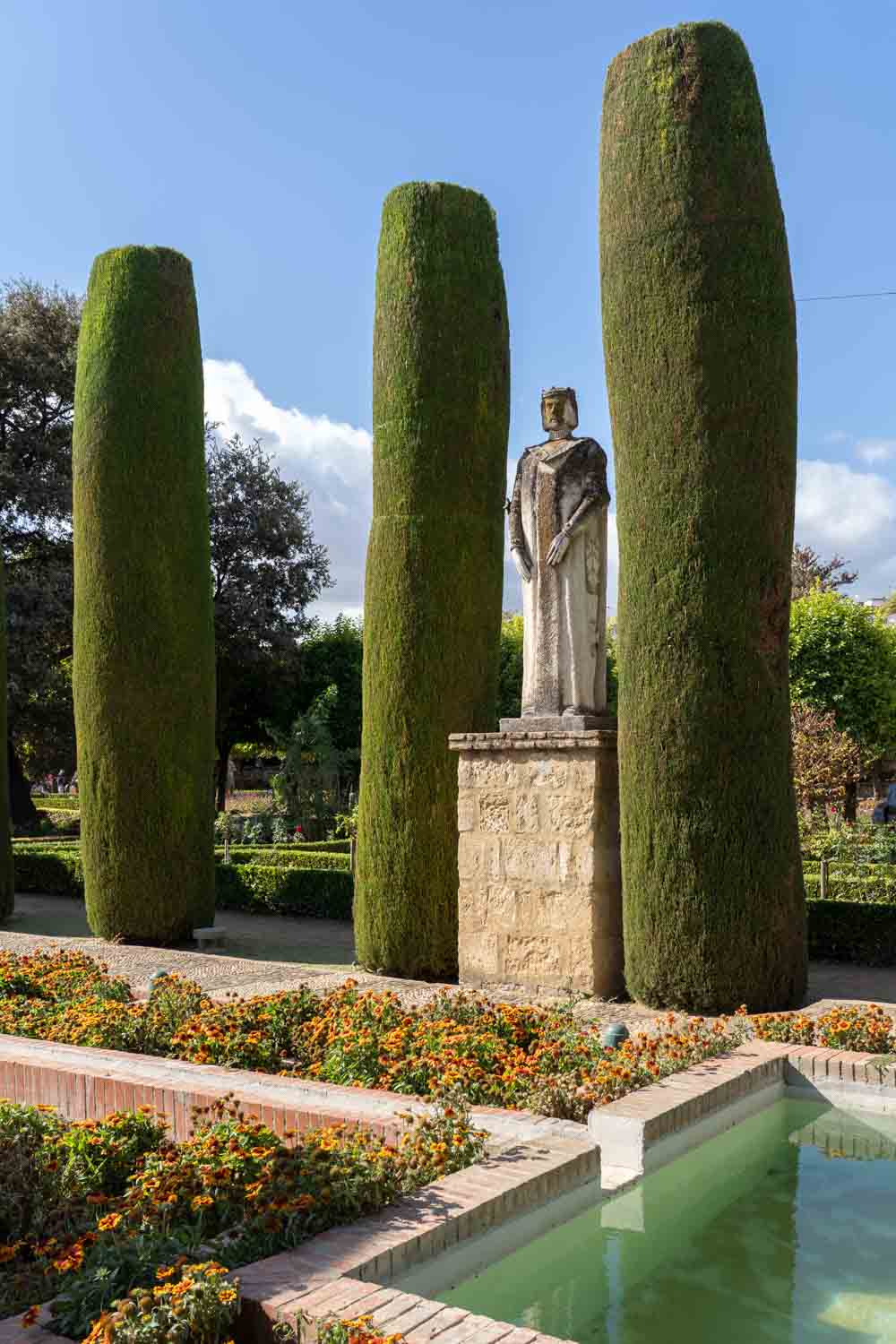Formal garden with reflecting pool and statue of a king