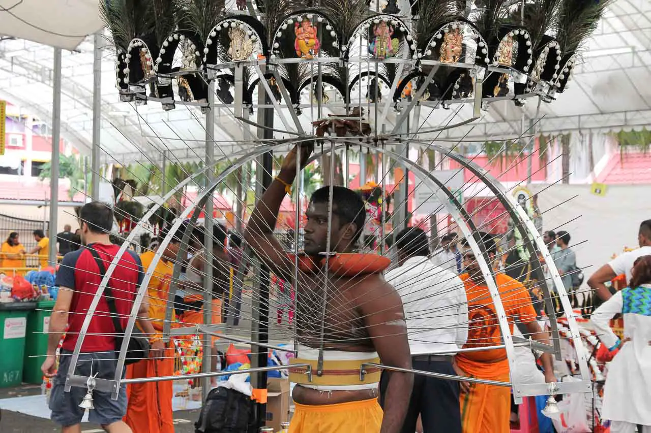 Man waiting to begin the pilgrimage in his Kavadi