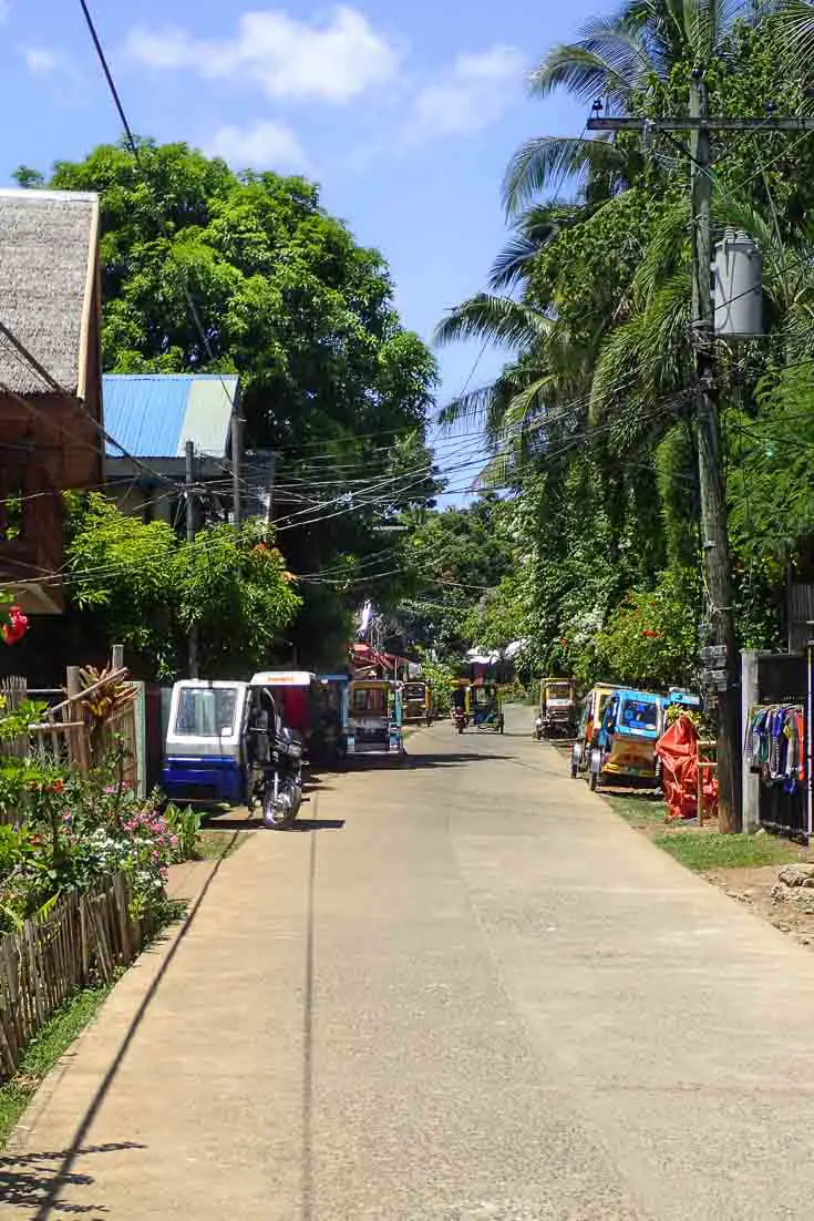 Laidback Boracay streetscape with tuk tuks and palm trees