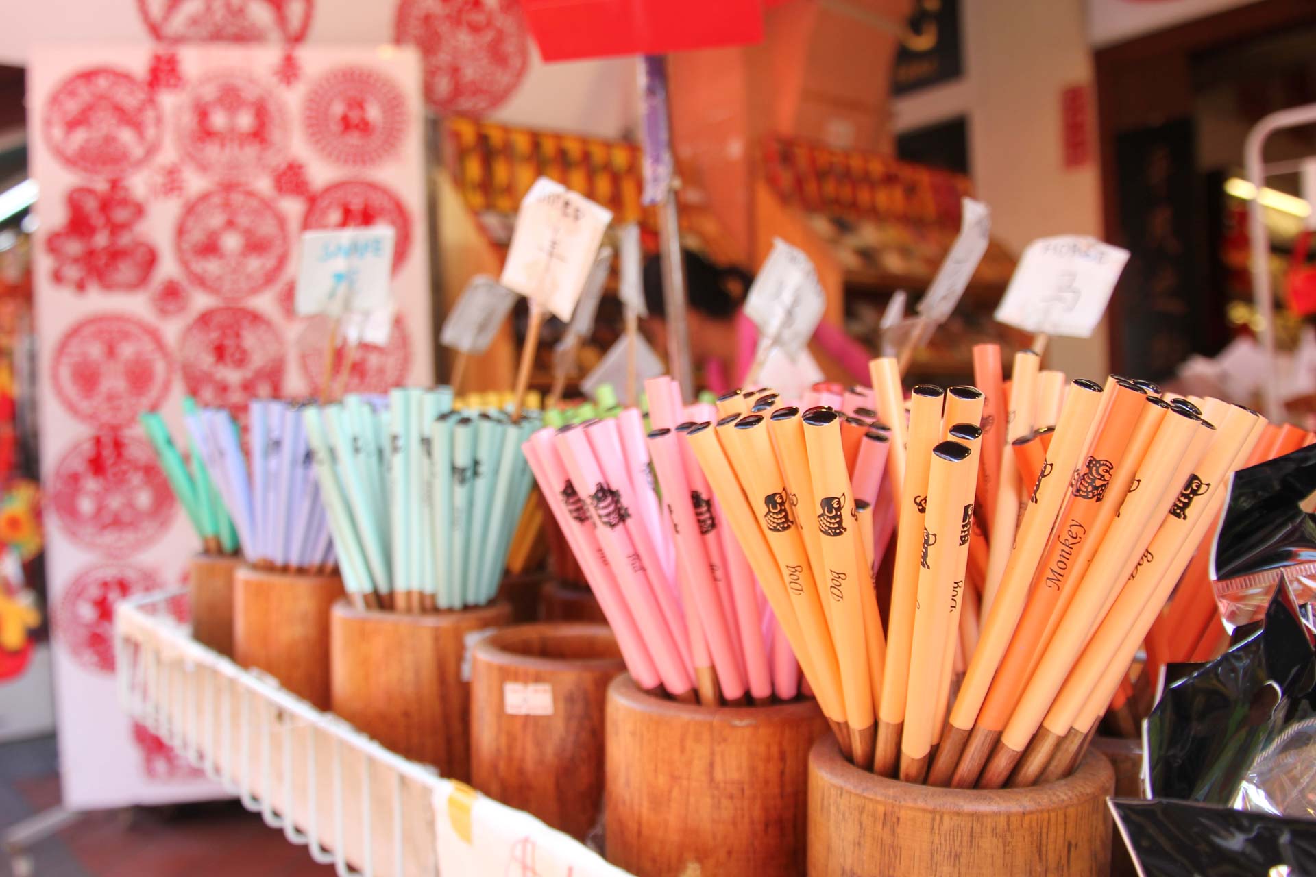 Wooden containers with coloured chopsticks that bare different zodiac signs