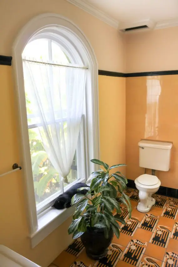 Bathroom with arched window and graphic yellow and black tiles