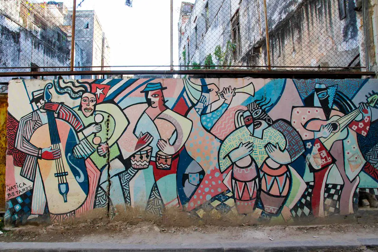 Colourful mural of musicians with Cuban flag on a concrete wall