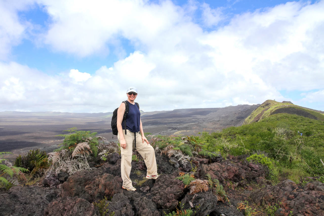 Woman standing on the rim of a volcanic crater