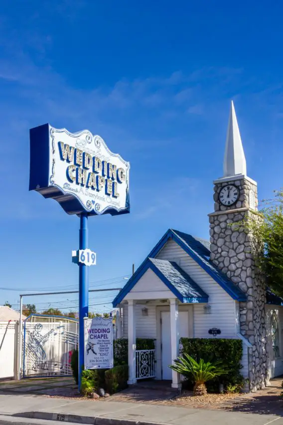 Small white and blue wedding chapel with stone steeple
