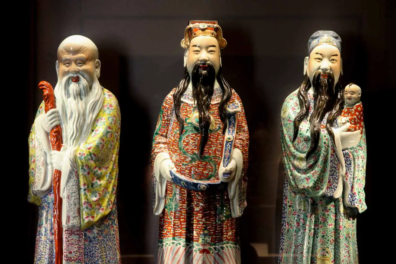 Three porcelain figurines of Chinese gods