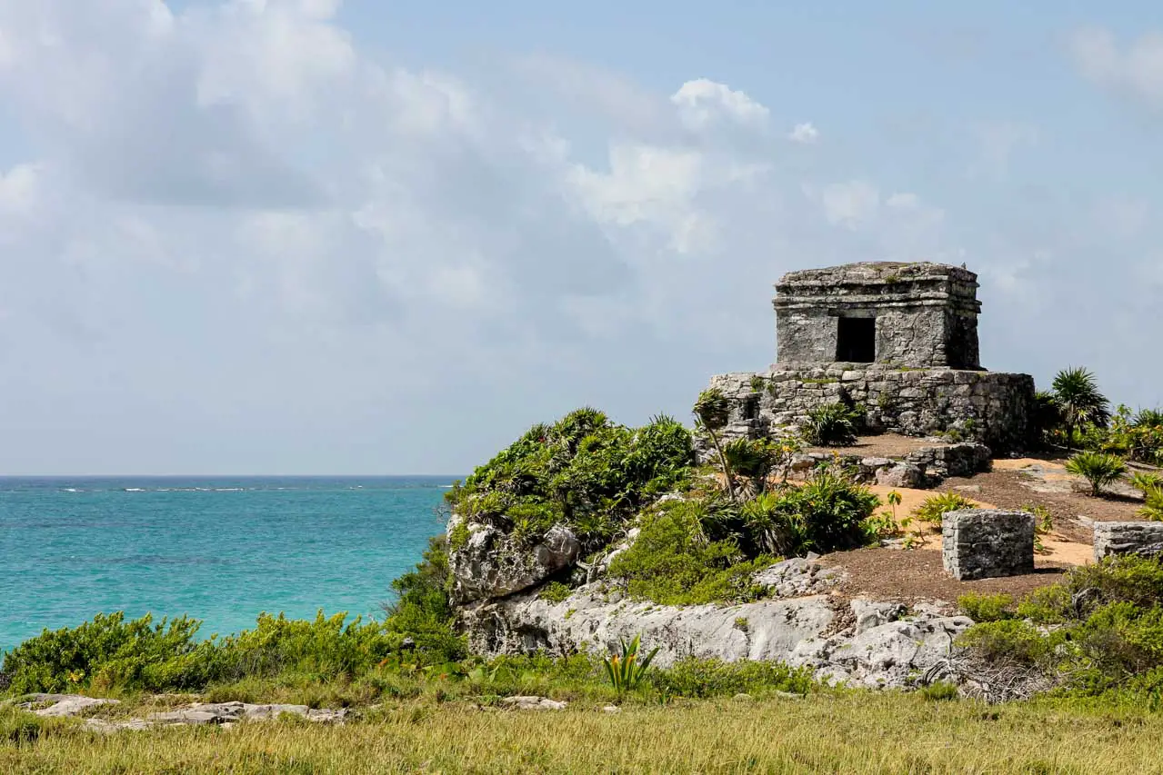 Ruins of stone watchtower overlooking aquamarine waters