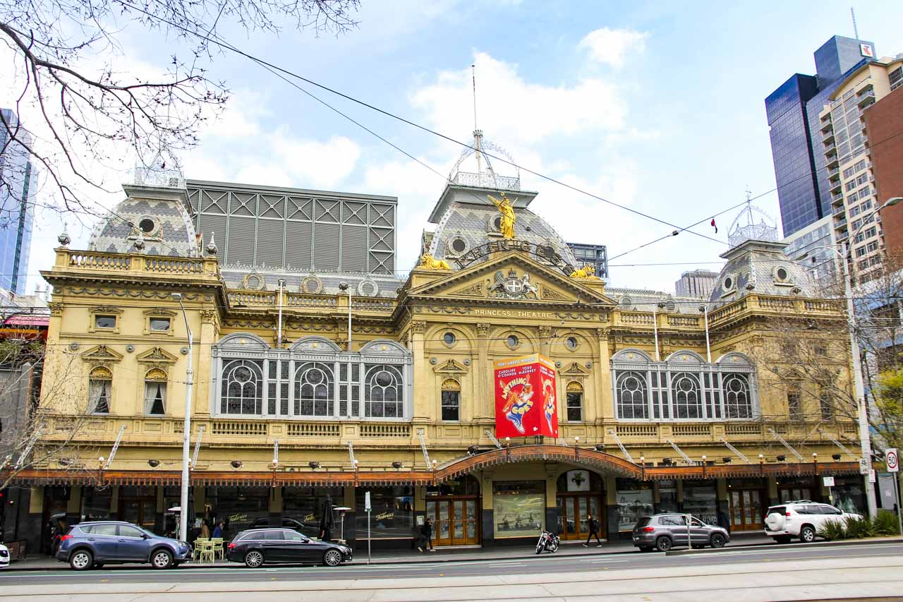 Exterior of historic, Second Empire-style theatre painted in yellow