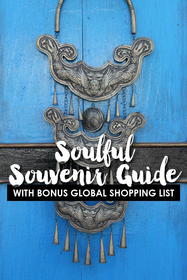 Ornate silver necklace hanging on bright blue door with text overlay "Soulful Souvenir Guide"
