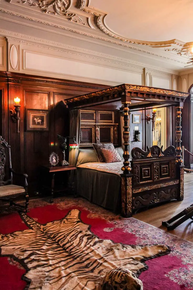 Sir Pellatt's bedroom with dark wood four-poster bed and rich furnishings