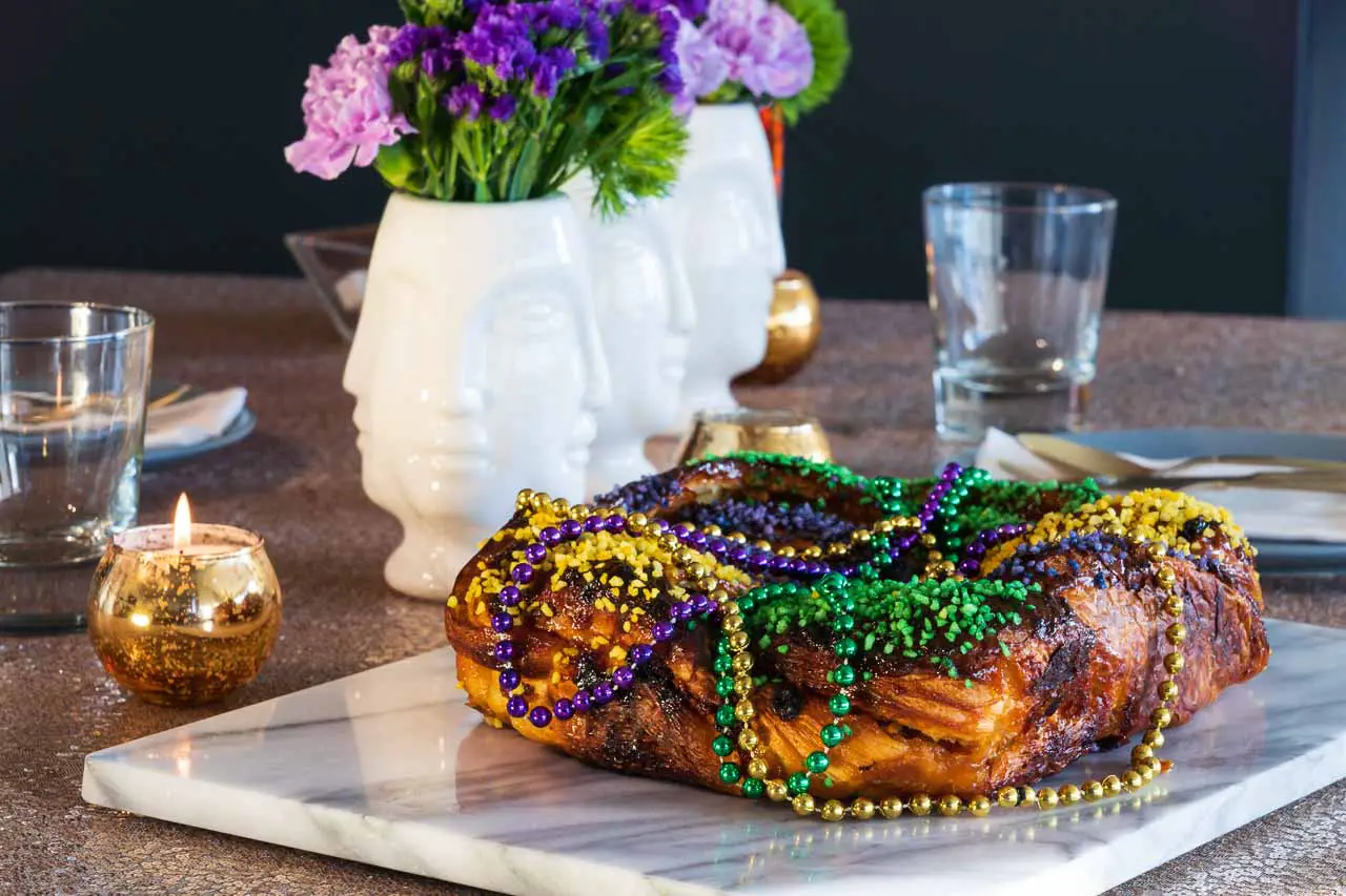 Mardi gras beads decorating a King Cake
