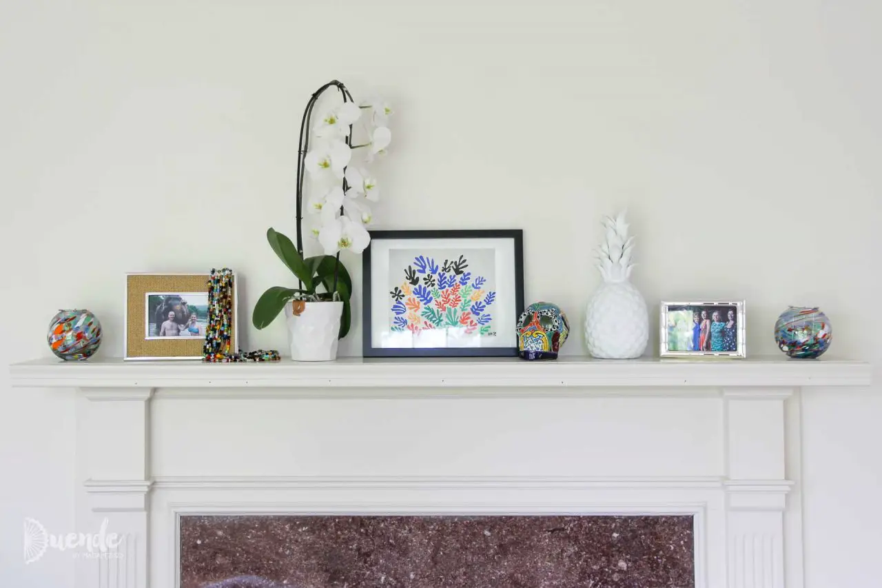 Mantlepiece souvenir display including Matisse print from MoMa, calavera from Mexico and beads for Mardi Gras