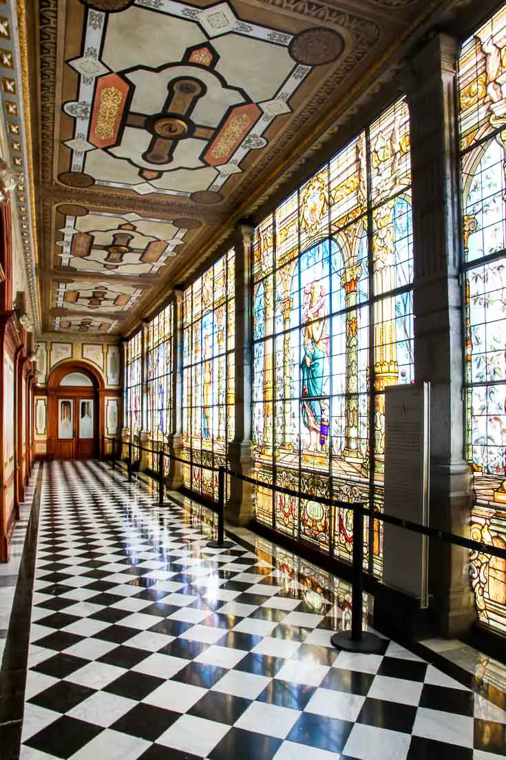 Hall with stained glass wall and chequered floor tiles