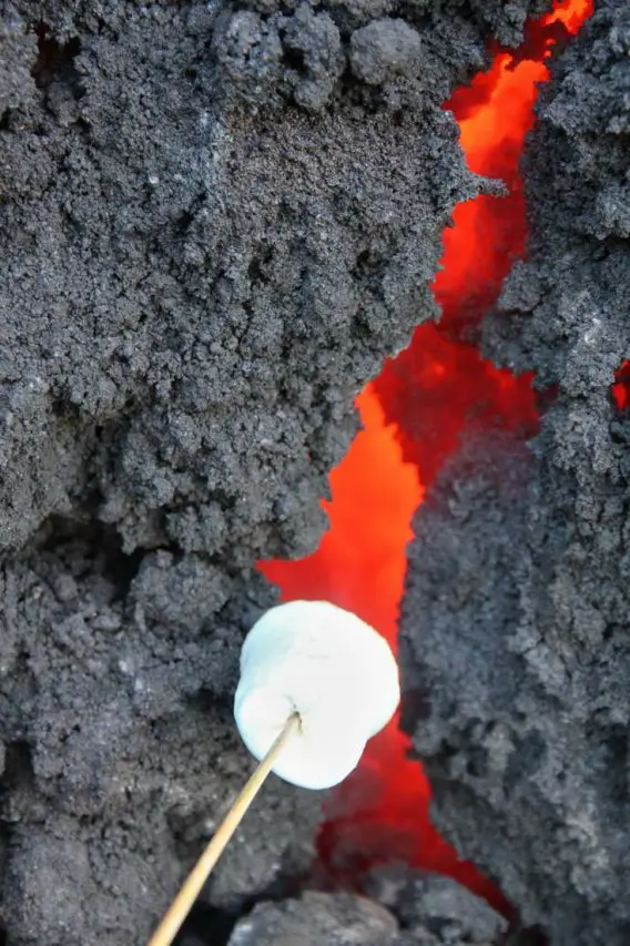 Marshmallow being held over red-hot lava