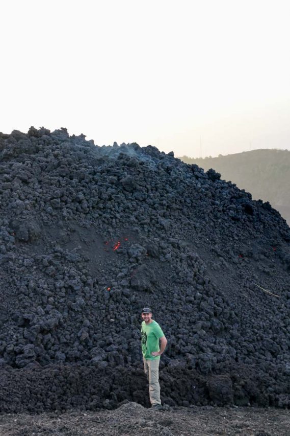 James standing at the face of a slow-moving lava flow