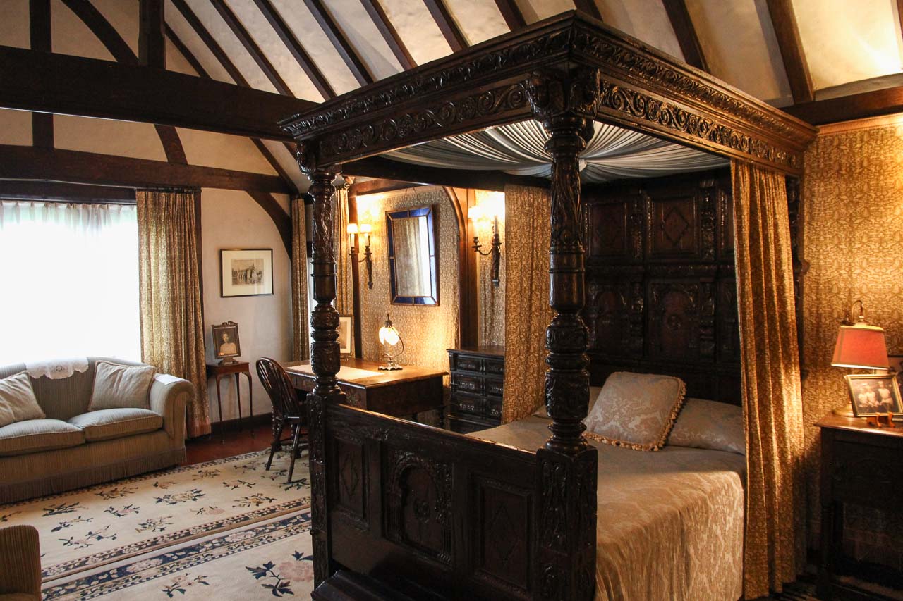 Tudor revival bedroom with dark wood, four-poster bed