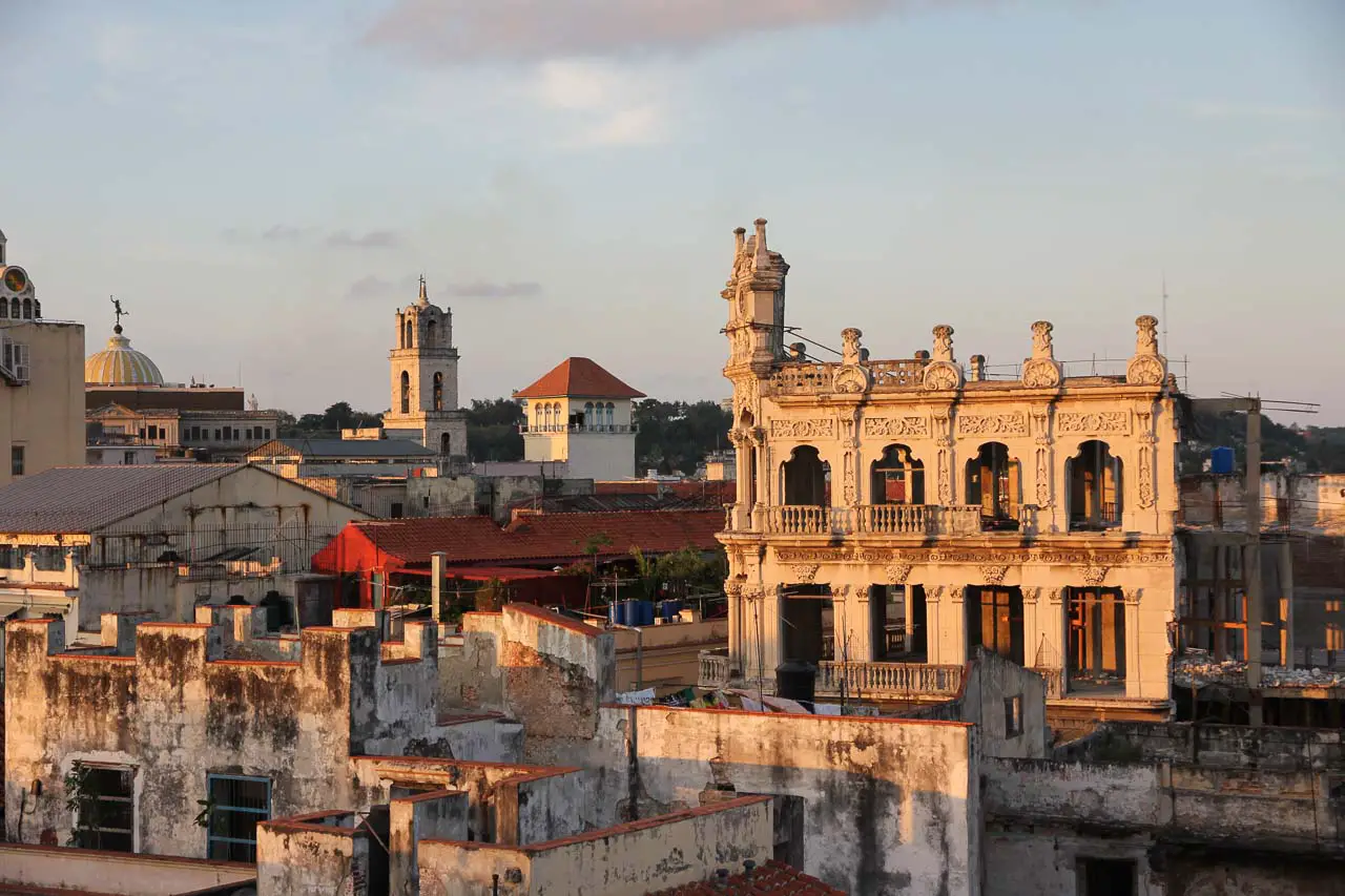 Sunset glow across dilapidated old colonial buildings with ornate facades