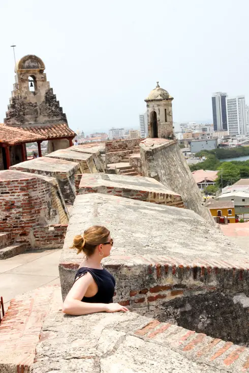 Woman looking out from fortress on hill