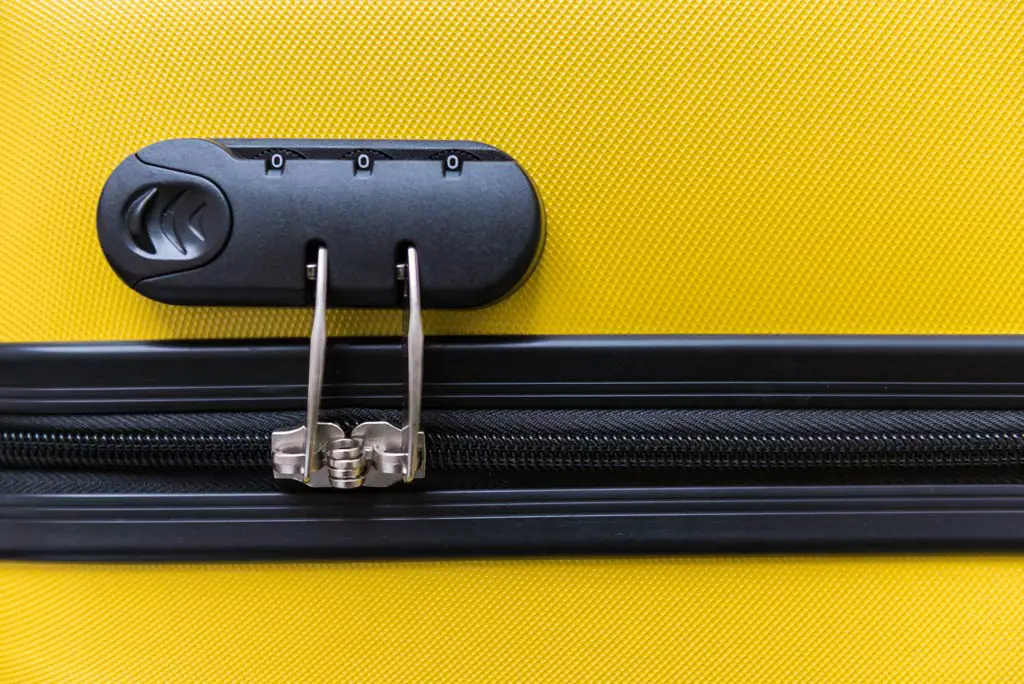 Close up of zipper lock on yellow suitcase