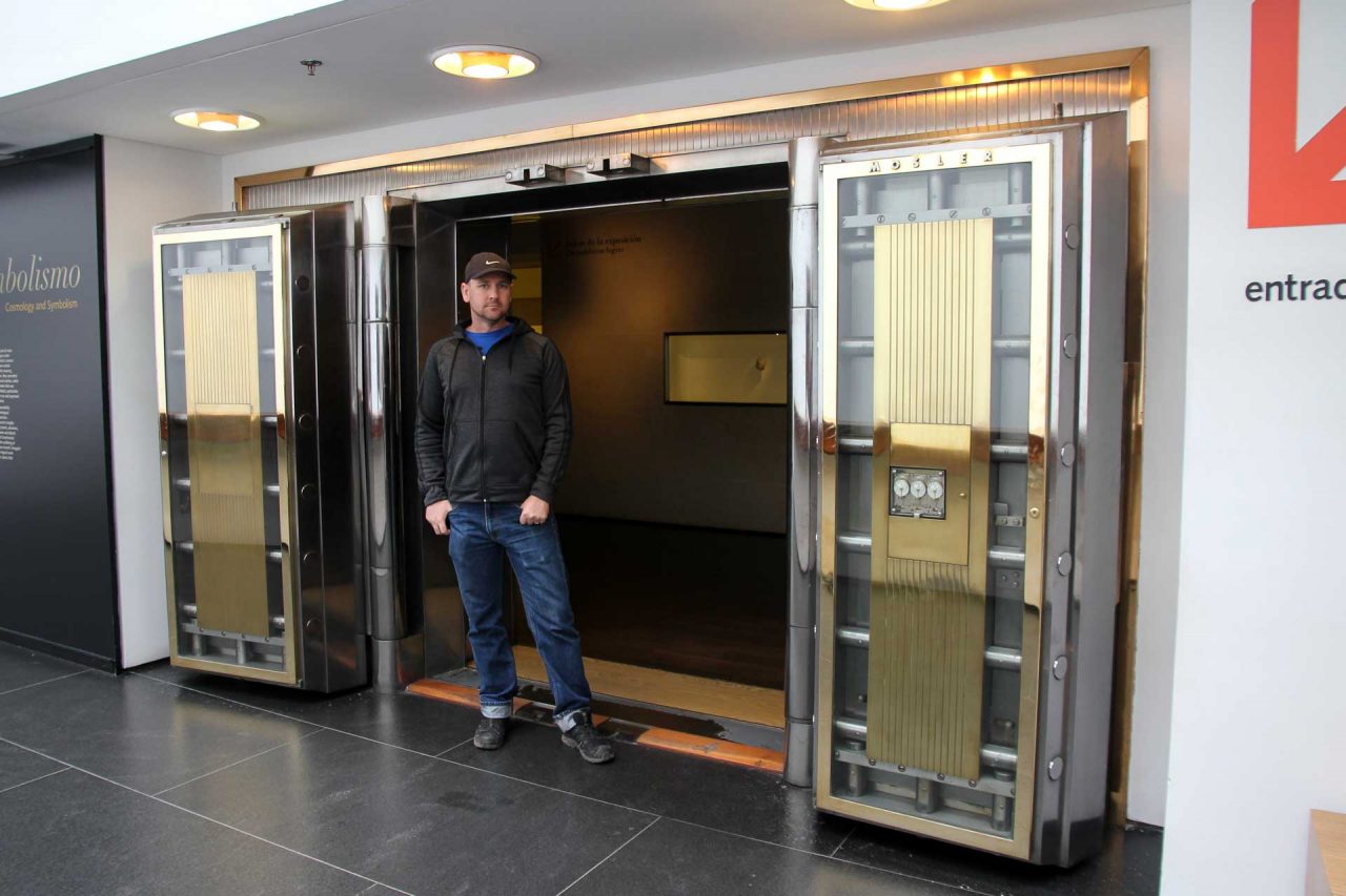Man standing in doorway framed by vault-like doors